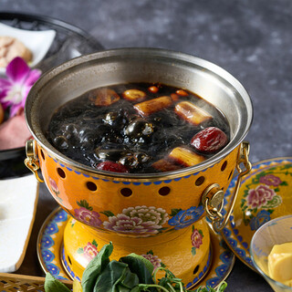 "Yunnan's Beautiful Mushroom Hot Pot: Secret Black Soup with Mushroom Broth and Medicinal Herbs"